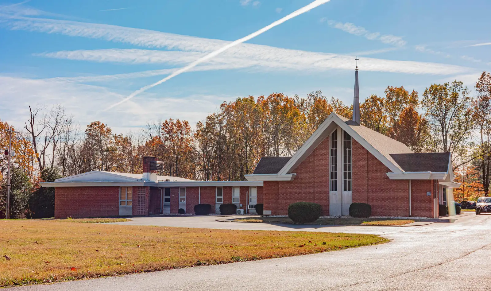 New Geneva Community Church, a red-brick church with a tall steeple, on Buckner Lane in Paducah in autumn